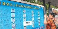 2018年6月21日，安徽省阜阳市清河路一公交站台上晒失信被执行人名单，吸引群众目光。王 彪摄 - 新浪吉林